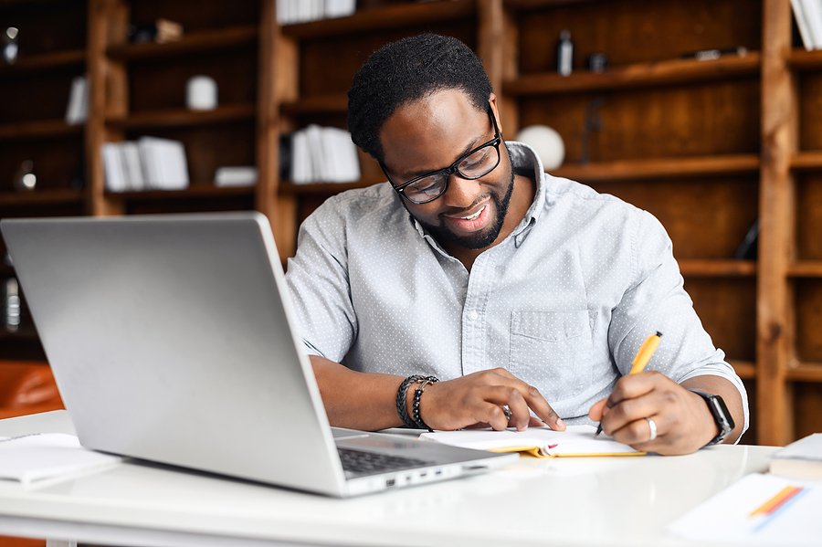 Concentrated Positive Hispanic Man In Eyeglasses Thinking, Takin